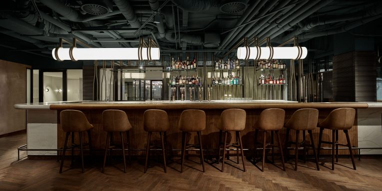 A Retro Café in Amsterdam Boasts a White Marble Bar and Exposed Pipes 1