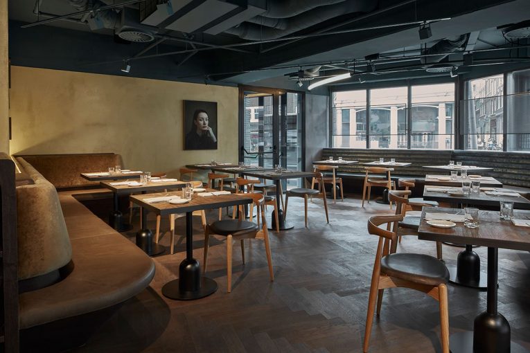 A Retro Café in Amsterdam Boasts a White Marble Bar and Exposed Pipes 9